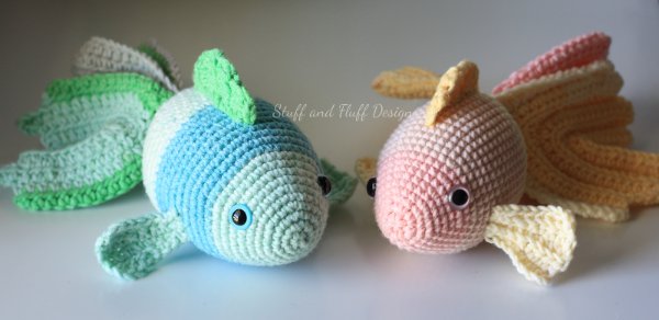 Two pretty crocheted goldfish with long tails.