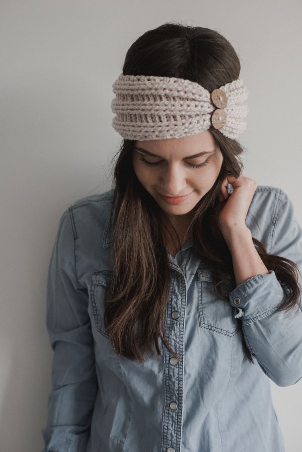Woman wearing a crochet headband with buttons.
