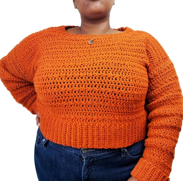 A closeup of a plus size crochet cropped sweater.