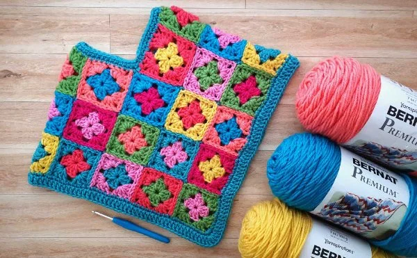 A brightly coloured crochet poncho for toddlers.