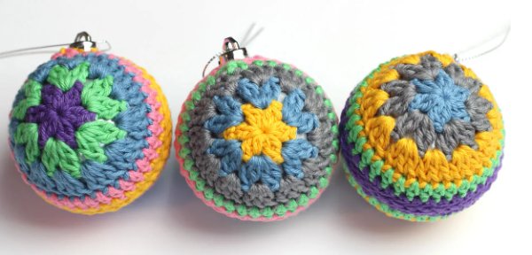 Three crochet Christmas baubles featuring the granny stitch.