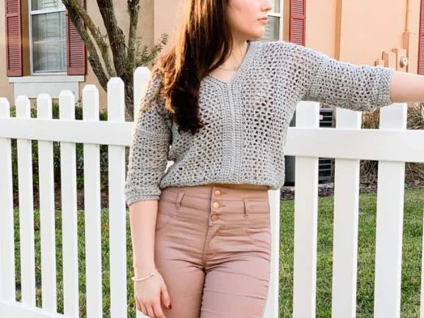 A lacy crochet cropped sweater with a v-neckline.