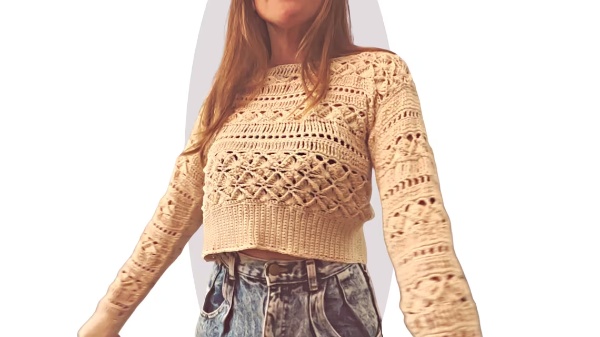 A crochet cropped sweater with lacy panels.