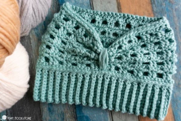 A blue crochet messy-bun headband with a ribbed edge.