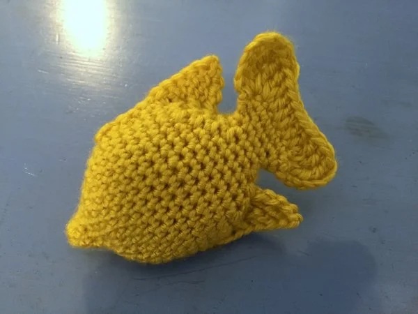 A crocheted Yellow Tang fish.
