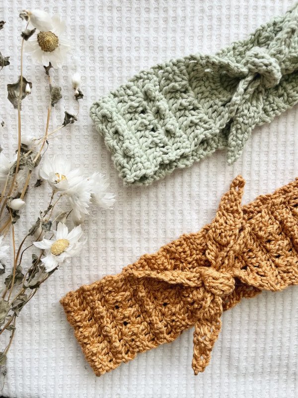 A flat lay image of two different coloured crochet headwraps.