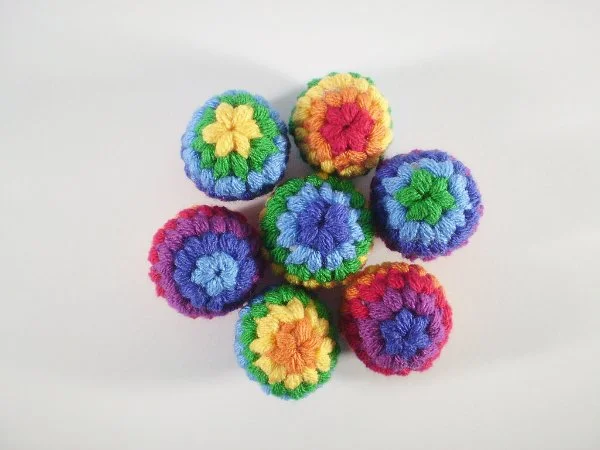 A pile of brightly coloured crochet balls.