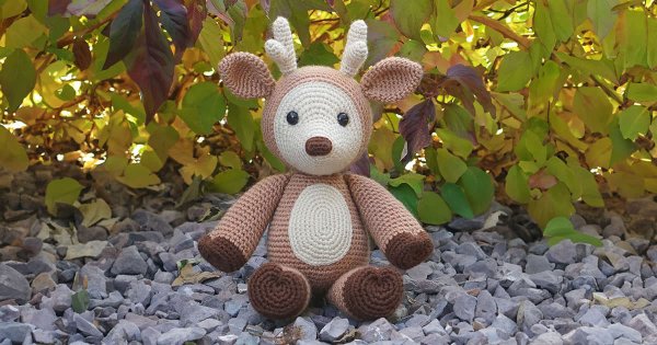 A stuffed crochet deer toy.