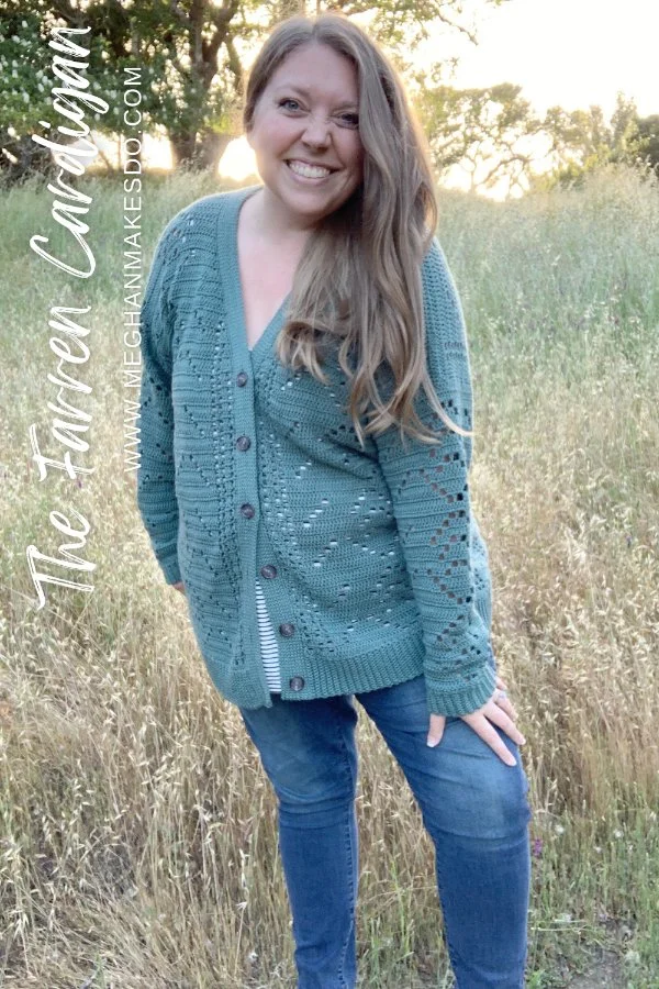 A woman outdoors, wearing a lacy crochet buttonup cardigan.