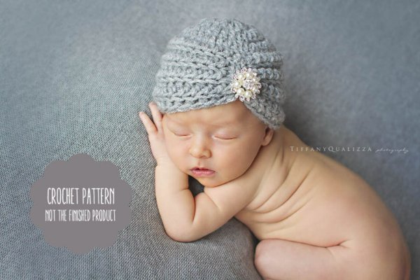 A newborn baby wearing a crochet baby turban.