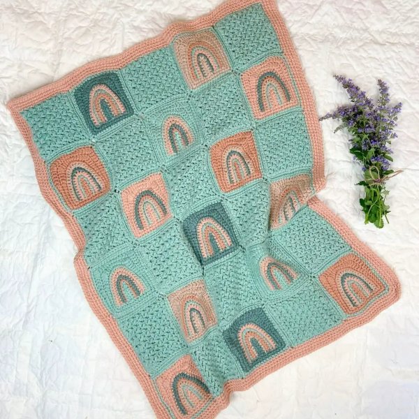 A rainbow granny square baby blanket.