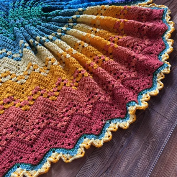 A rainbow ripple crochet baby blanket.