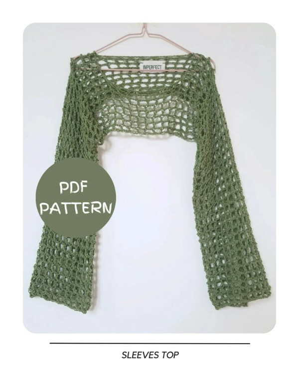 A green crochet sleeves top hanging from a coat hanger.