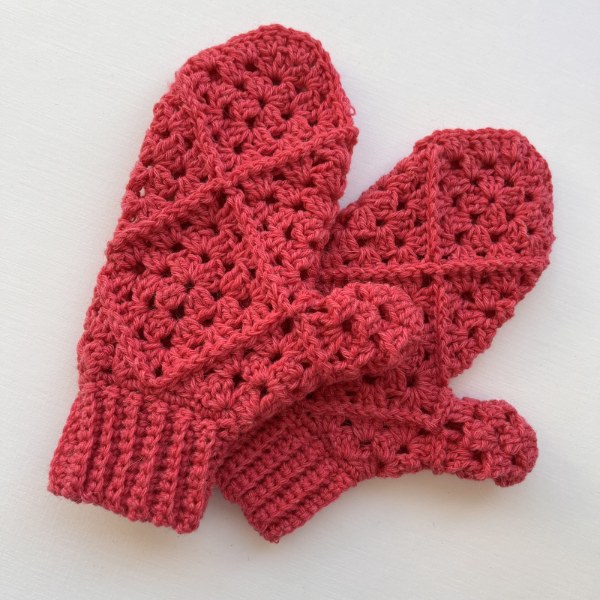 Red children's granny square mittens.