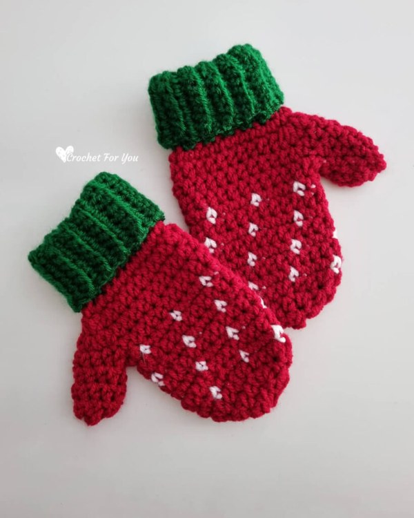Strawberry-themed kids crochet mittens.