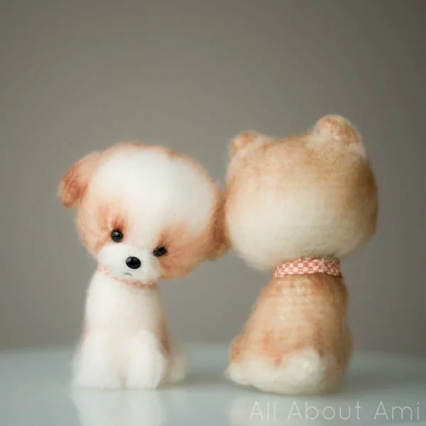 Front and back view of a fluffy crochet dog with a bandana.