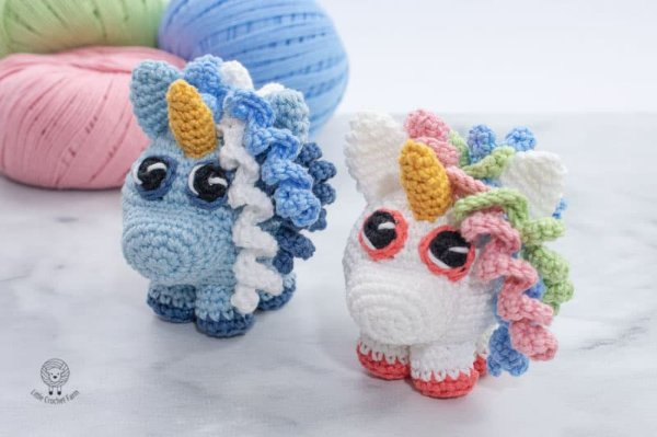 Two crochet unicorns made in different colours.