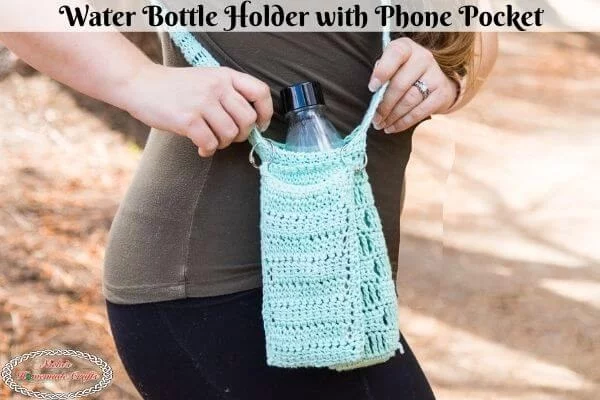 A crochet water bottle holder with an attached phone pocket.