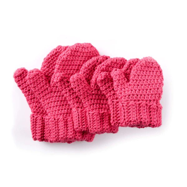 Bright pink crochet mittens in a range of sizes.