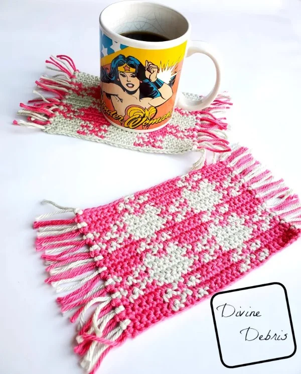 Two pink and white gingham print crochet mug rugs.