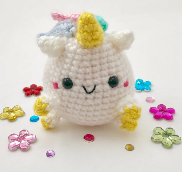 A short, pudgy crochet unicorn.