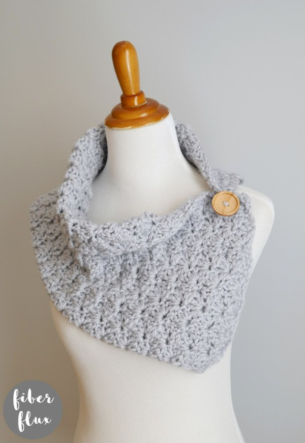 A light gray coloured crochet button cowl.