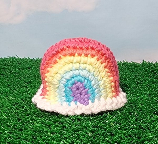 A rainbow crochet egg warmer.