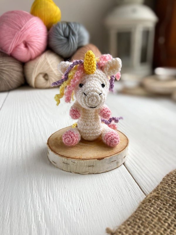 A crochet mini unicorn amigurumi.