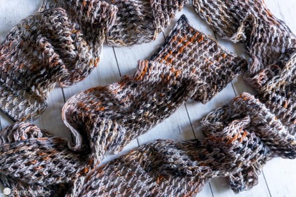 A narrow, Tunisian crochet scarf with an openwork mesh stitch design.