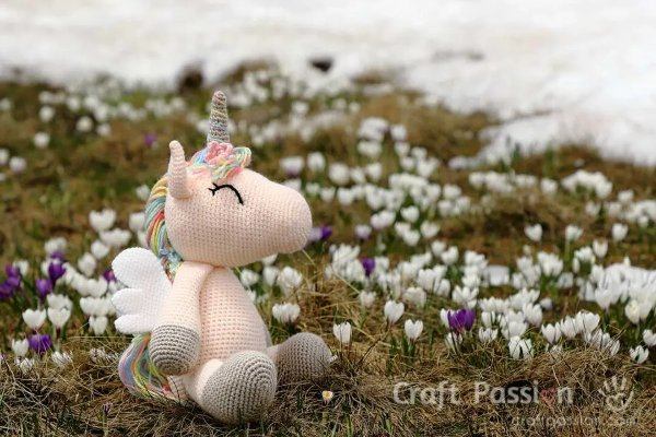 A crochet unicorn toy with wings.