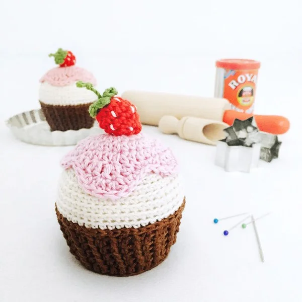 A crochet strawberry cupcake pin cushion.