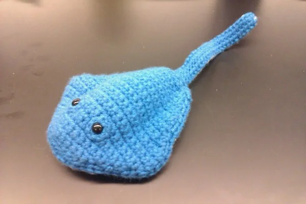 A blue amigurumi stingray toy.