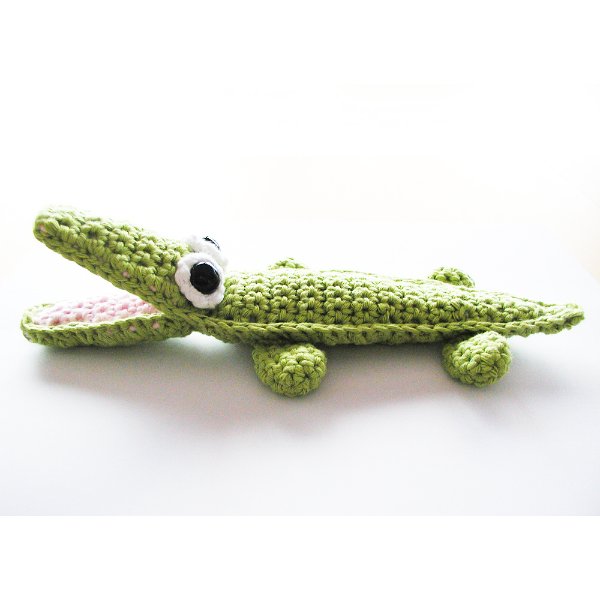 A small crochet alligator with an open mouth.