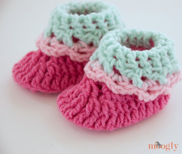 Newborn crochet baby booties with a fold down cuff.