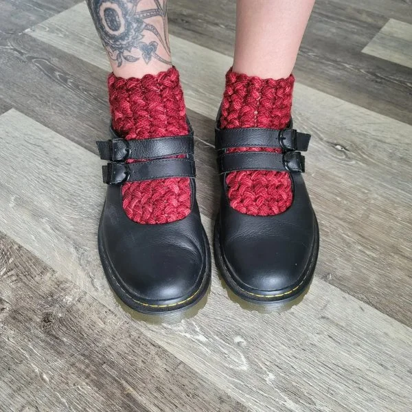 Red crochet ankle socks worn with black maryjanes.