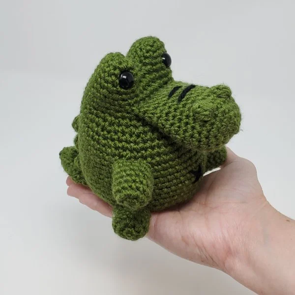 A chubby crochet alligator amigurumi.