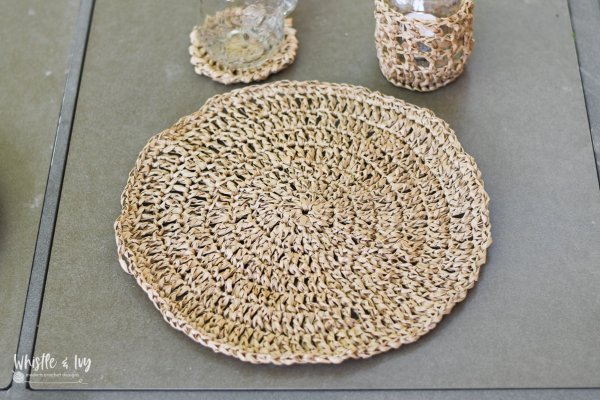 A round, raffia crochet placemat.