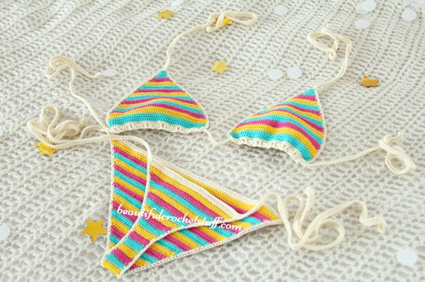 A brightly coloured, striped crochet triangle bikini.