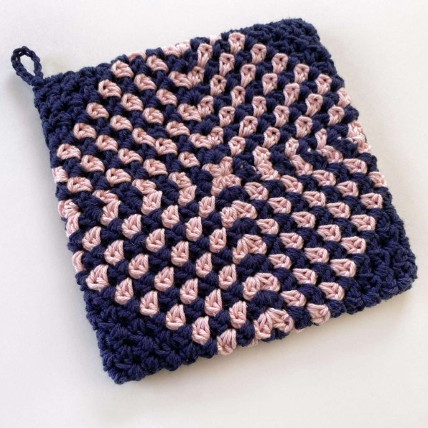 A pink and black granny diamond potholder.