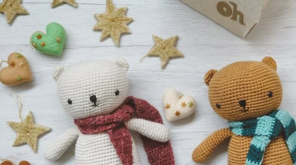 Two crochet teddy bears wearing scarves.