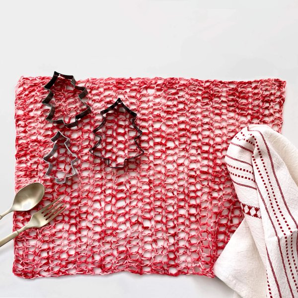 An airy crochet placemat worked in a mesh stitch.