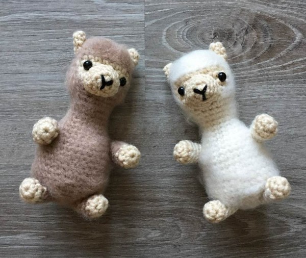 Two mini crochet alpacas with fluffy fur.