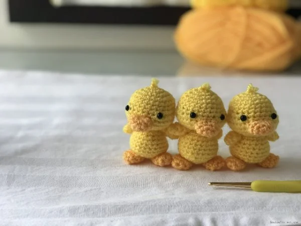 Three yellow duckling amigurumi.