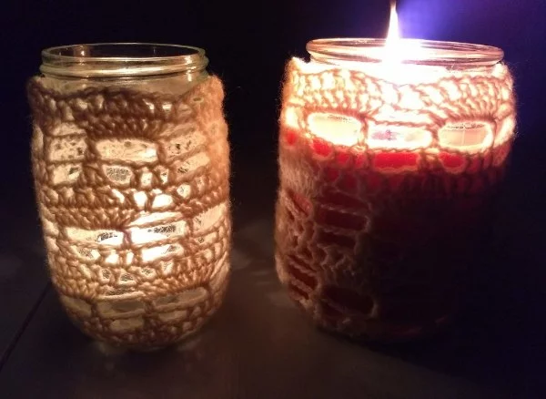 Two tealight jars with crochet covers.