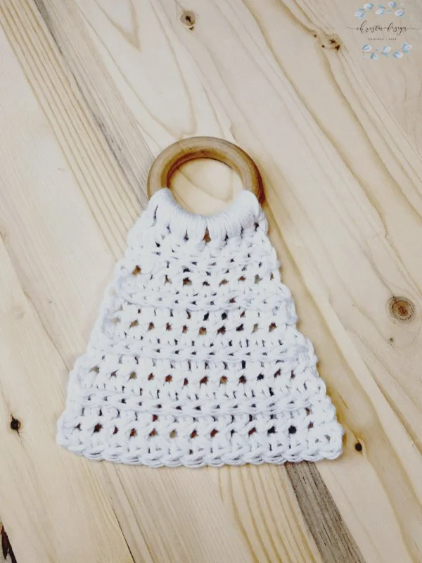 A simple crochet lovey comforter attached to a wooden teether ring.