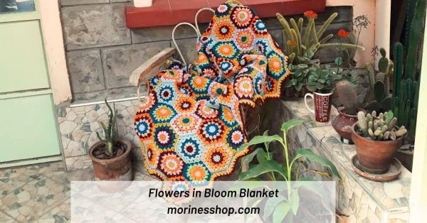 A classic crochet hexagon blanket in a garden.