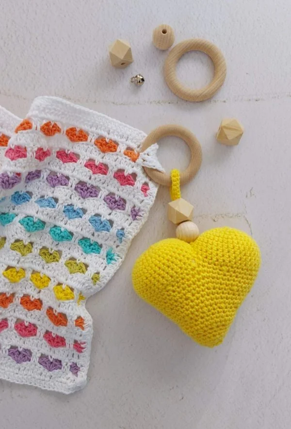 Simple crochet lovey with a rainbow heart pattern.