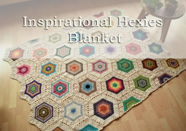 A crochet blanket featuring multi-coloured hexagons with white join-as-you-go borders.