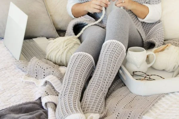Long grey crochet socks with a waffle stitch design.