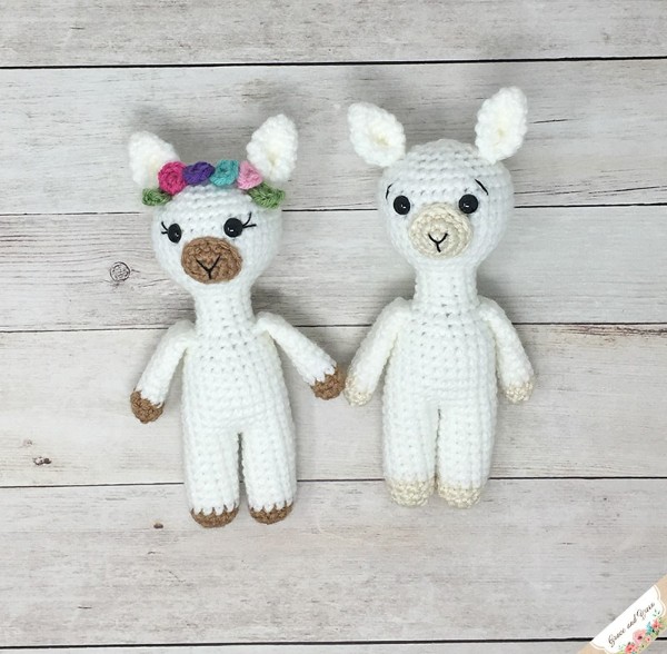 A flat lay image of two white crochet llamas.